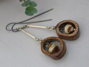 Bone rondelles, Czech glass, brass and blackened titanium wire.