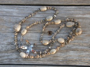 Bronze, silver, agate, mother-of-pearl, seed beads, on hemp cord.
