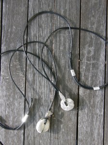 Ceramic bead, silver, iron, leather cord.