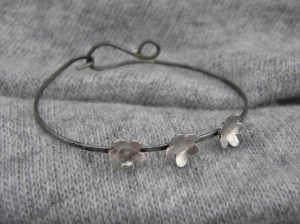 Sterling silver flowers on blackened, polished iron wire (nickel free).